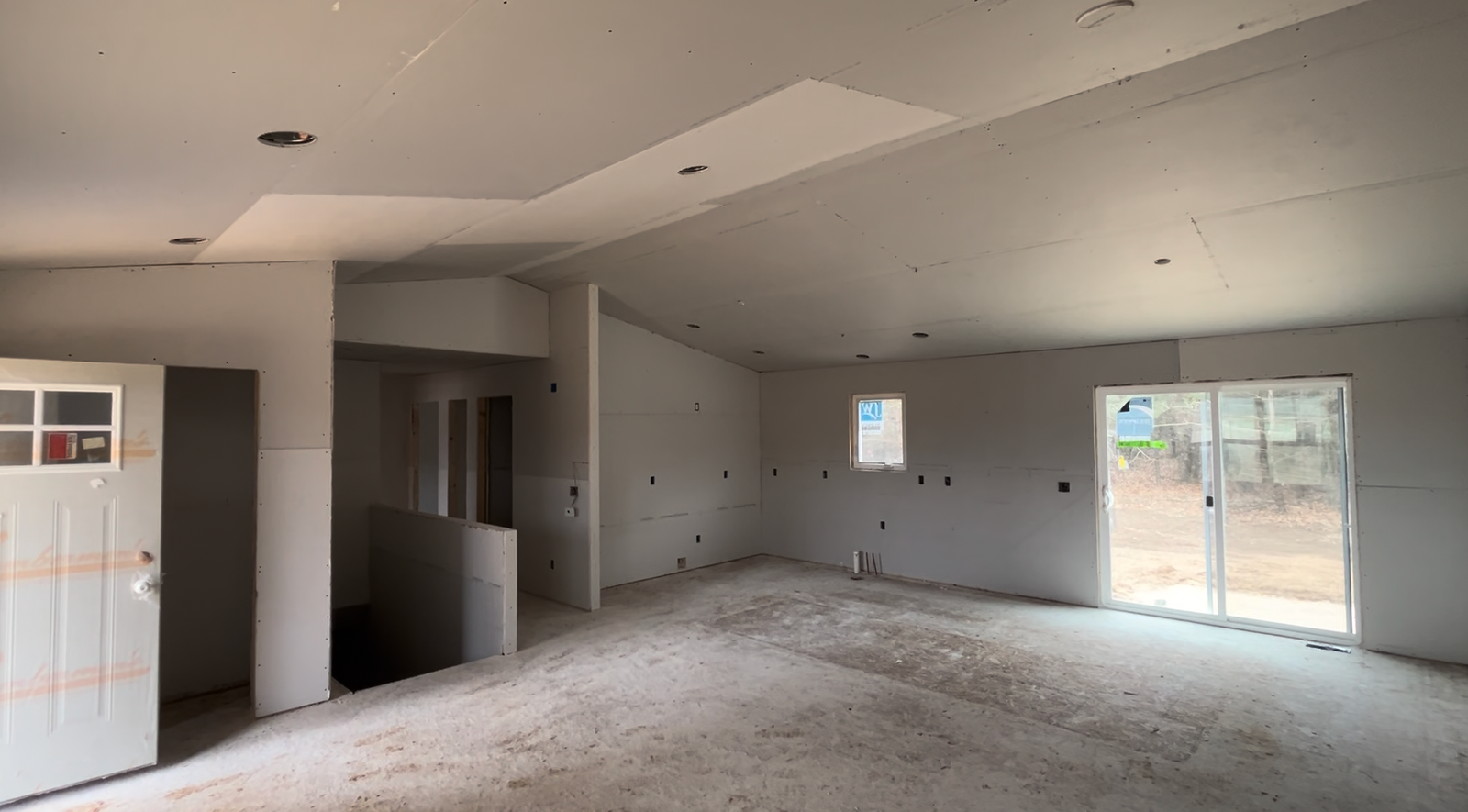Empty residential room with drywall and recessed lighting